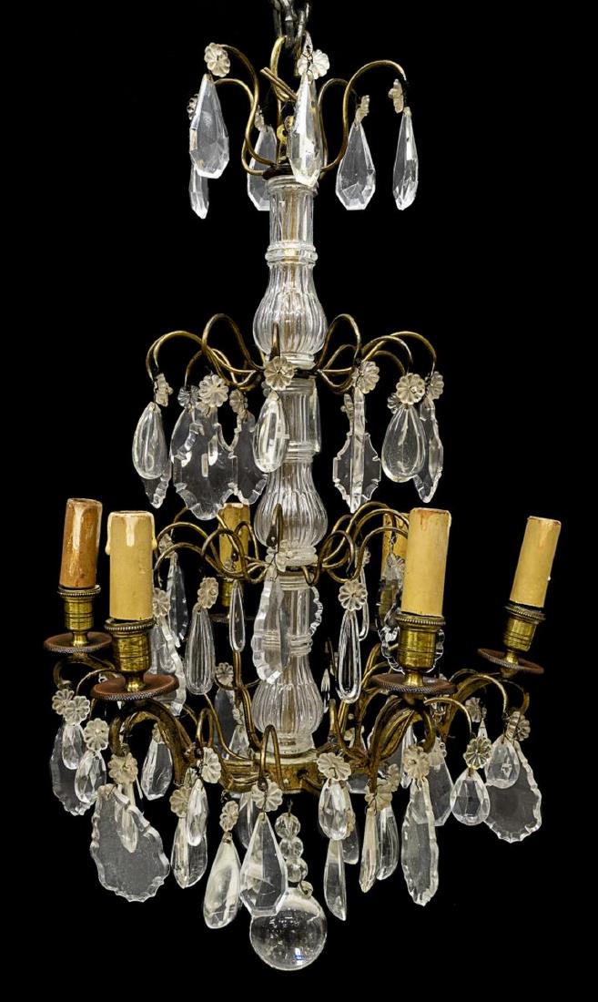 FRENCH MARIA THERESA STYLE 6-LIGHT CHANDELIER: French Maria Theresa style gilt metal and crystal six-light chandelier, 20th c., having four tiers of crystals, with six candles encased in faux candle covers, accented by center drop finial, in need 