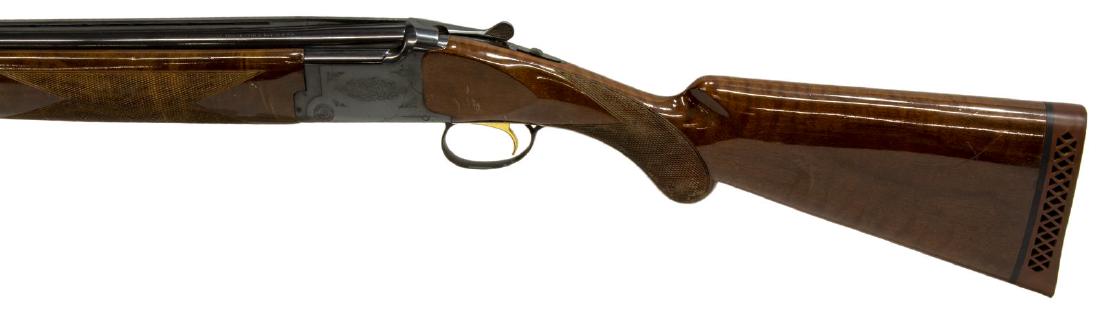 BROWNING CITORI SUPERPOSED 12 GAUGE SHOTGUN: Browning Citori Superposed shotgun, 12 gauge, 28" vent rib barrels, gilt trigger, barrel selector, foliate engraving at receivers, checkered stock and forestock, Browning recoil pad, browning leather