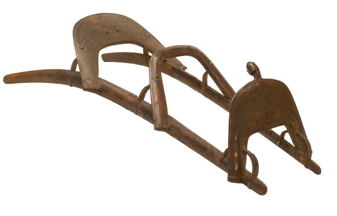 METAL-CLAD WOODEN CAMEL DROMEDARY SADDLE: Metal-clad wooden camel saddle, two basal rails and three arched supports, approx 12"h, 19"w, 53"d **Note: a similar style saddle was used by Napoleonâ€™s Dromedary Regiment (Regiment des Dromeda