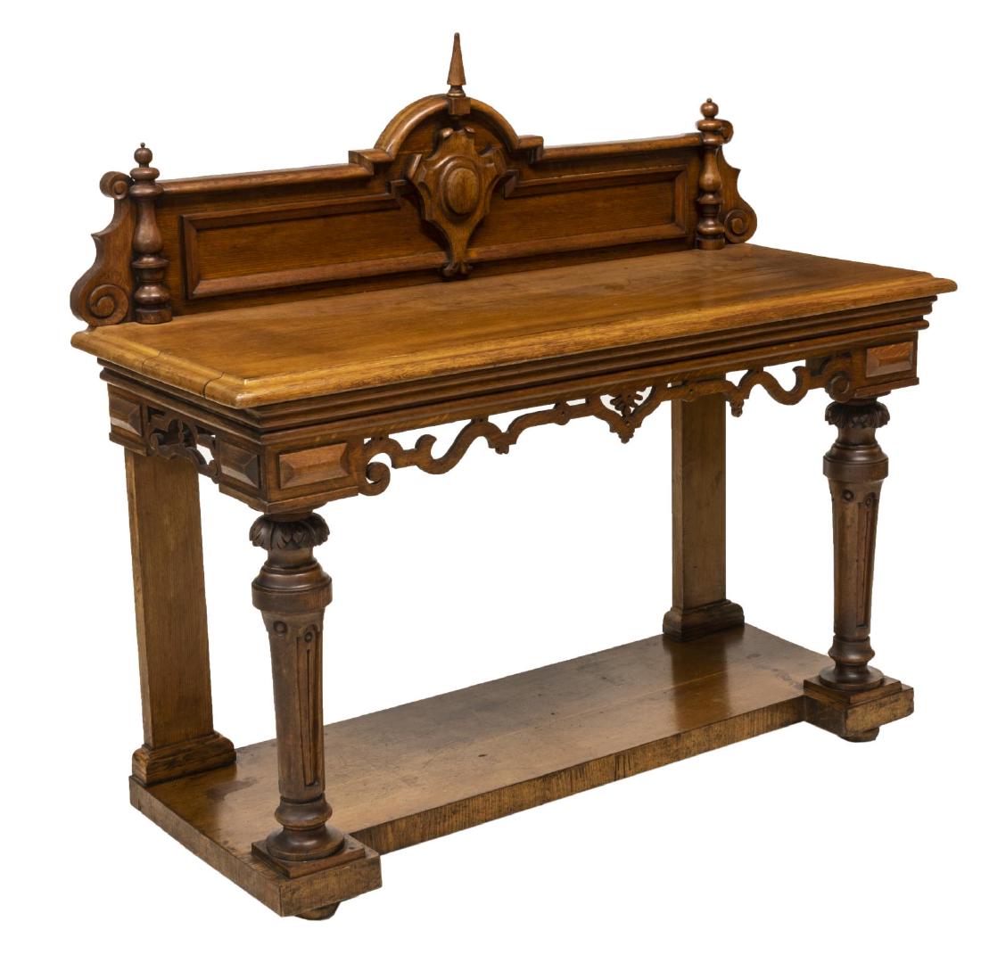 AMERICAN RENAISSANCE REVIVAL OAK SERVER BUFFET: American Renaissance Revival oak server, early 20th c., having raised back with carved center cartouche topped with pointed finial, flanked by half-turned pilasters, long rectangular top, with pierced