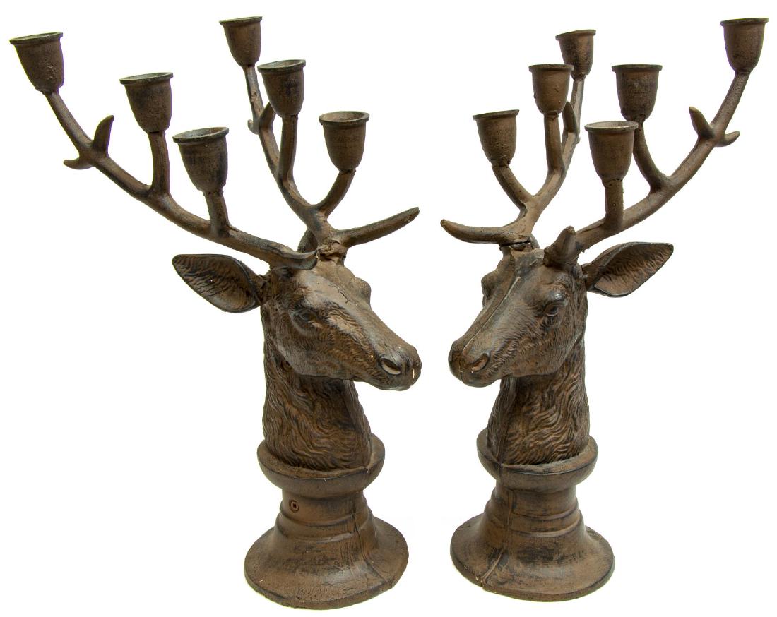 2)PATINATED CAST IRON DEER HEAD ANTLER CANDELABRAS: (pair) Large patinated cast iron six-light candelabras, each modeled as a deer head, antlers mounted with candle cups, raised on a circular base, one antler loose, approx 19.5"h, 8.5"w, 17"d, 28lbs **