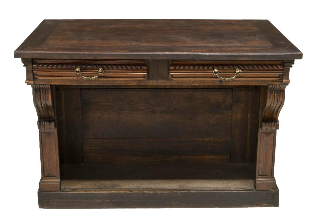 FRENCH CARVED OAK STORE COUNTER W/ DRAWERS: French store counter, c.1900, the paneled front flanked by scrolling corbels, the back with two drawers over an open storage space, all rising on a later plinth base, 33.25"h, 48.5"w, 27.5"d **Provena