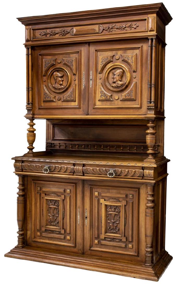 FRENCH HENRI II STYLE WALNUT DEUX CORPS BUFFET: French Henri II style walnut deux corps buffet, early 20th c., having cornice top, frieze with foliate molding, upper double-door cabinet with carved profiles in roundels, on turned supports, backboar