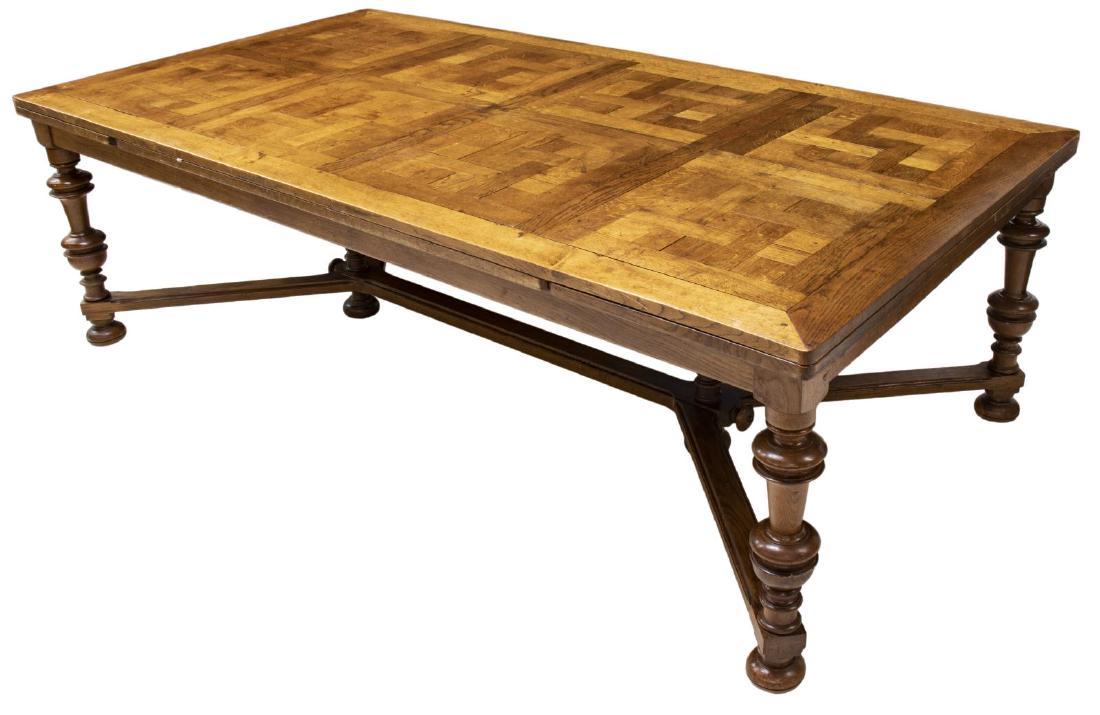 FRENCH PARQUETRY DRAW LEAF DINING TABLE, 131"W: French Provincial oak dining table, late 19thc., parquetry top with draw leaves, rising on stretcher-joined turned legs, ending in bun feet, approx 29"h, 93.25"w, 29"d, open: approx 131"w Start Price: