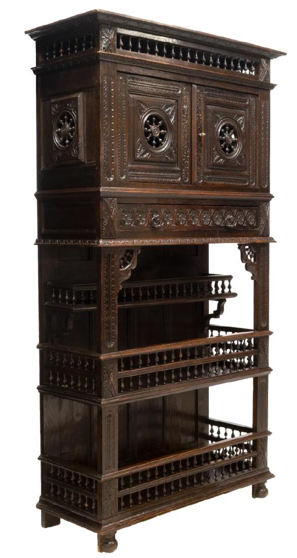 FRENCH BRETON CARVED DISPLAY CABINET: French Breton display cabinet, 19thc., foliate carving with substantial use of spindle decoration, the protruding cornice over two doors, the lower part with three display shelves, all rising on bun f