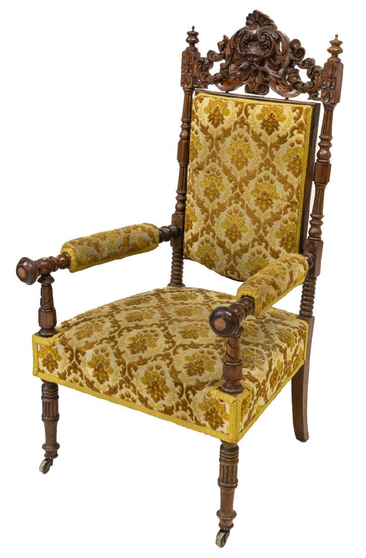 FRENCH RENAISSANCE REVIVAL CARVED WALNUT ARMCHAIR: French Renaissance Revival heavily carved walnut armchair, late 19th c., having mask, foliate and floral carving, foliate upholstery, the backrest flanked by turned standards, rising on turned front l