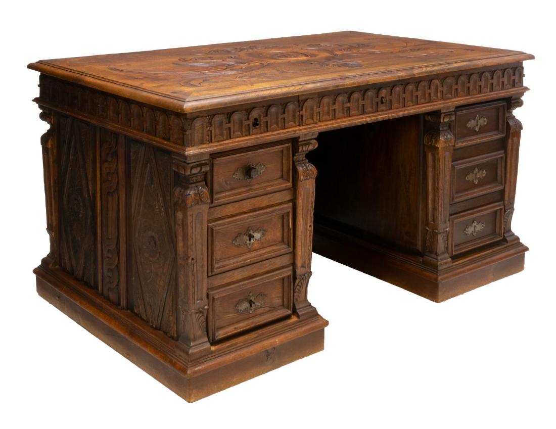 FRENCH RENAISSANCE REVIVAL HIGHLY CARVED DESK: French Renaissance Revival oak kneehole pedestal desk, late 19th c., having foliate, vase and geometric carving, the rectangular top with incised carving depicting a centered monogram on shield held a