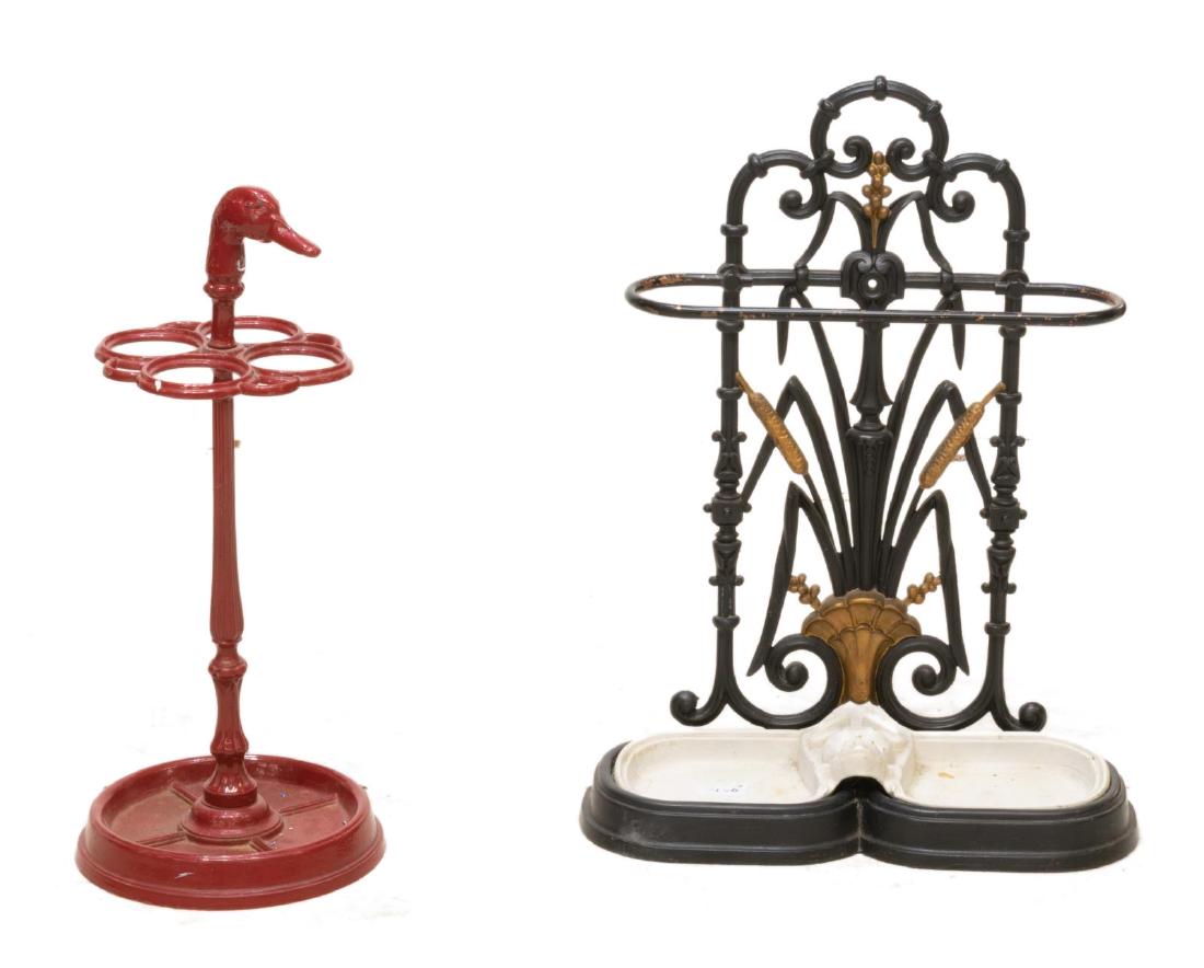 (2) PAINTED CAST IRON UMBRELLA CANE STANDS: (lot of 2) Painted cast iron umbrella or cane stands, early 20th c., including: (1) red stand, with duck head finial, four circular rings, on circular pedestal base, approx 25.25"h, 11"diam, (1) stand