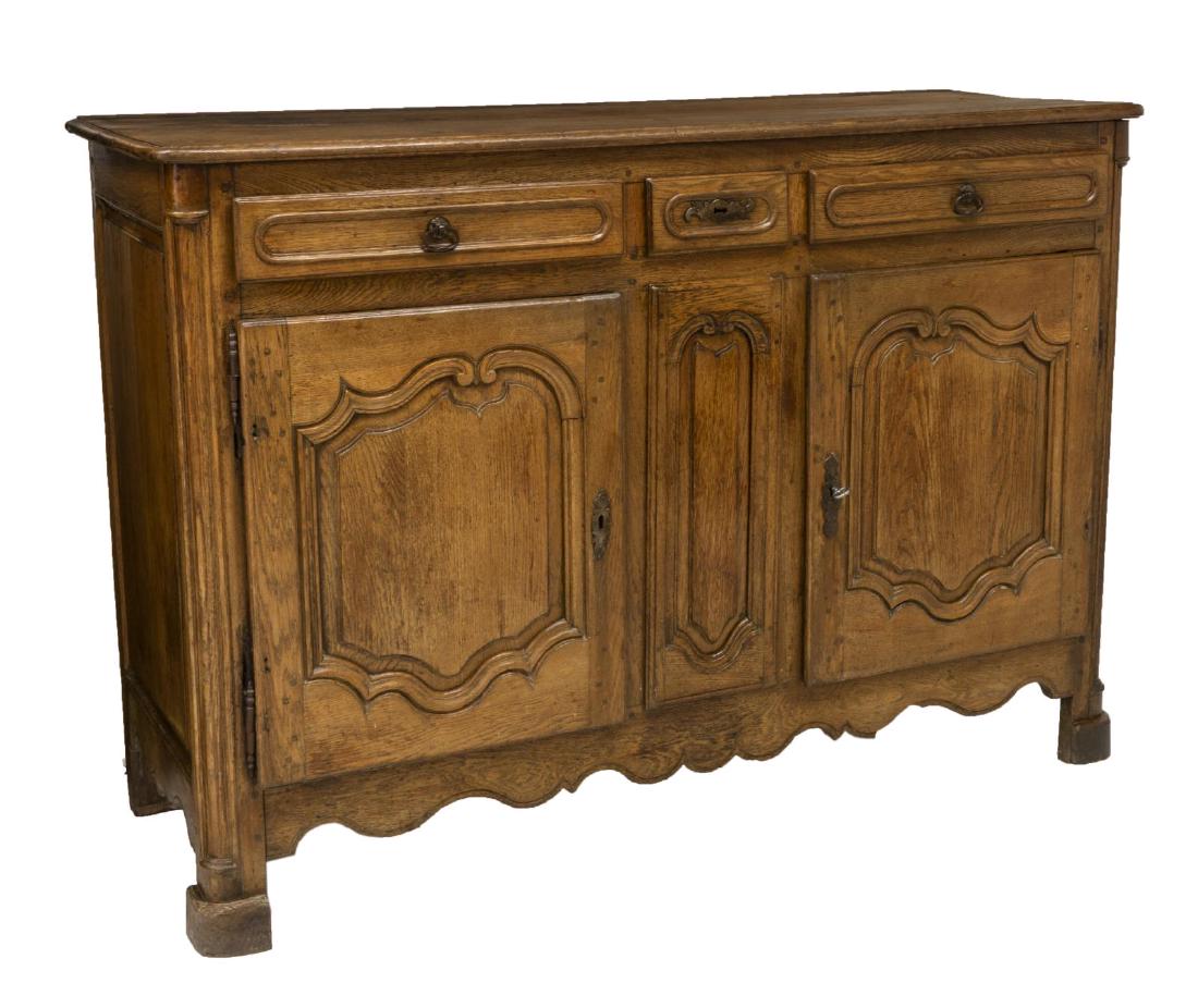 FRENCH LOUIS XV STYLE OAK BUFFET, 19TH C.: French Louis XV style oak buffet, 19th c., rectangular case with rounded corner posts, fitted with three drawers, over dual cabinets opening to shelf, paneled drawer and door fronts, scalloped apron, 