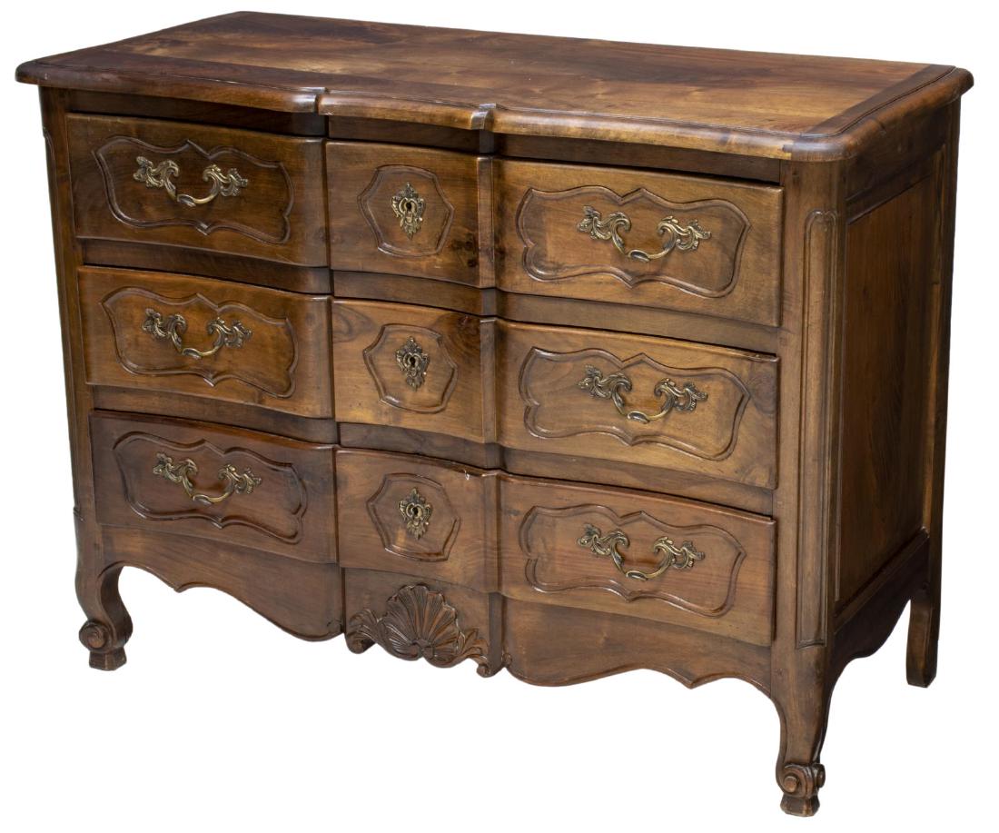 FRENCH LOUIS XV STYLE WALNUT COMMODE EN ARBALETE: French Louis XV style walnut commode en arbalete, late 19th c., fitted with three drawers, drawer fronts with molded panels centering gilt metal pulls, over shell-carved scalloped apron, rising on sho