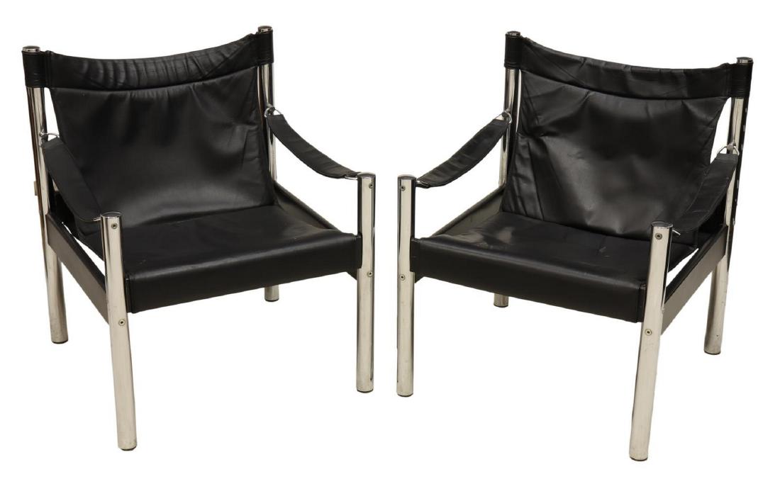 (2) MODERN TUBULAR CHROME LEATHER SAFARI CHAIRS: (lot of 2) Scandinavian modern Safari armchairs, c. 1960s-1970s, by Johanson Design, chromed tubular steel frame, with black leather sling seat and armrests, approx 30"h, 24.5"w, 24.5"d Start Price: $