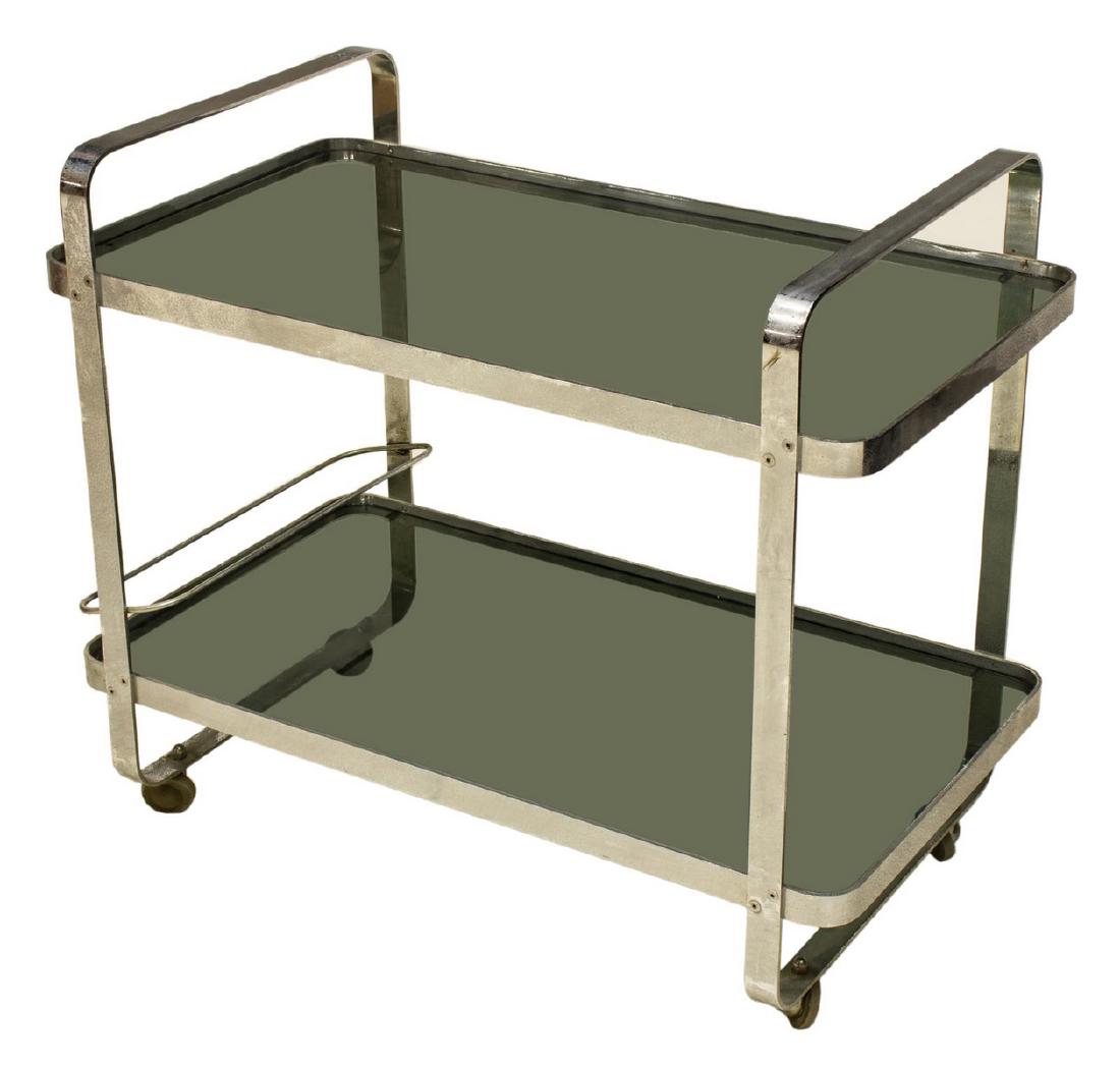 FRENCH MODERN TWO-TIER ROLLING SERVICE CART: French modern chromed steel service cart, c. 1970s, the handled cart having two inset smokey glass tiers, moving on castors, some spotting, patination to finish, approx 27"h, 31.5"w, 17.75"d Start Pri