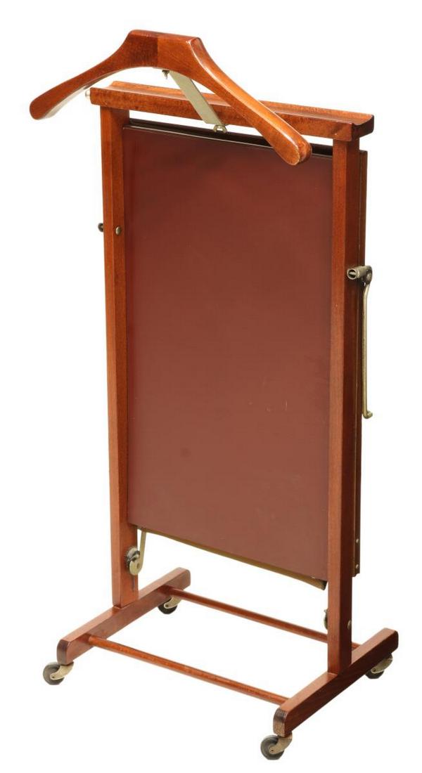 ITALIAN MID-CENTURY MODERN GENTLEMAN'S VALET: Italian mid-century modern gentleman's valet, mid 20th c., manufactured by Fratelli Reguitti, having clothes press with one side lined, resting on casters, approx 35"h, 17.75"w, 12.75"d Start Price: $