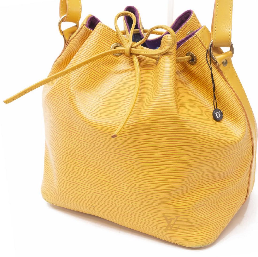 LOUIS VUITTON 'NOE PM' YELLOW EPI BUCKET BAG: Louis Vuitton â€œNoe PMâ€ bucket bag, in yellow Epi leather, with brass hardware, adjustable flat shoulder strap, drawstring closure at front face opening to purple Alcantara lined interior, cr