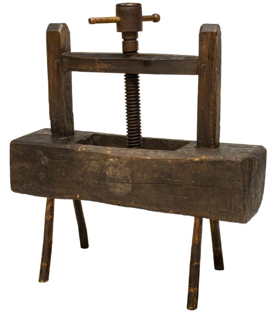 PRIMITIVE RUSTIC FRENCH WINE PRESS: Rustic French wine press, 19th c., having a turning wood press screw above the block body, rising on angled supports, approx 40"h, 16.5"w, 45"d Start Price: $150.00