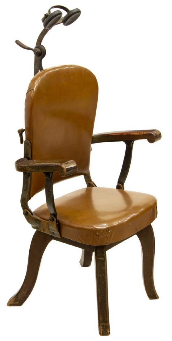 W.D. ALLISON DENTAL CHAIR: Dental chair by W.D. Allison Company, c. 1900, having an adjustable headrest, reclining back, upholstered in brown vinyl, rising on squared splayed legs, retaining makers tag, 50"h, 25"w, 21"d Start P