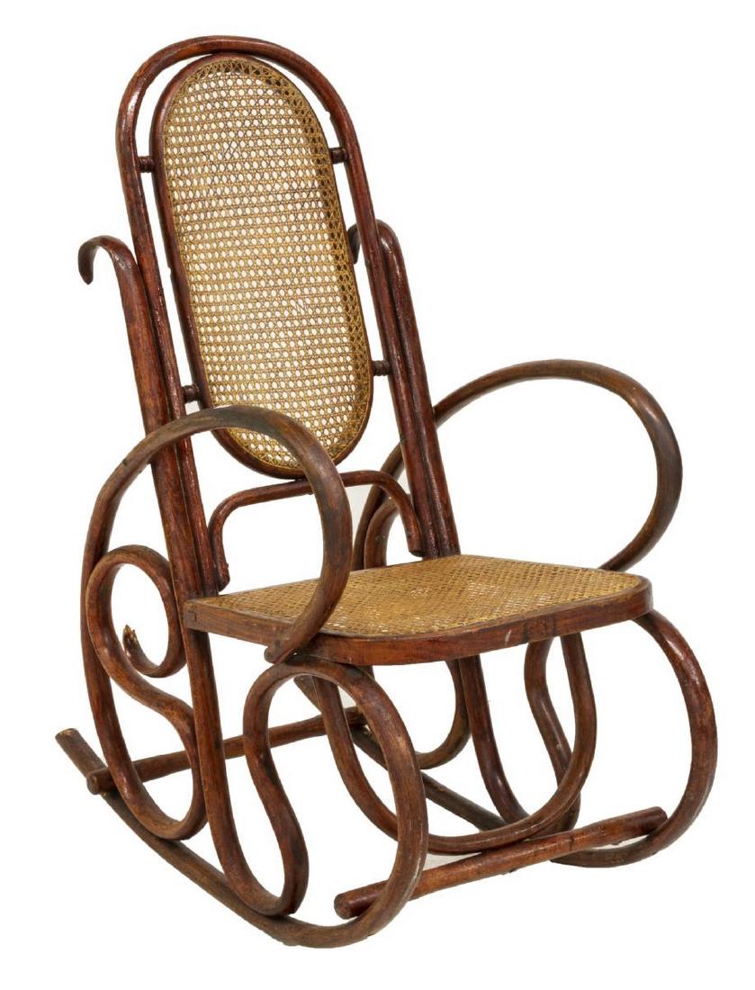 VIENNESE THONET STYLE BENTWOOD CANE ROCKING CHAIR: Viennese bentwood rocking chair, early 20th c., in the manner of Thonet, having a cane back and seat, rising on scrolled supports, loss and restoration, approx 42"h, 21"w, 37"d Start Price: $100.00