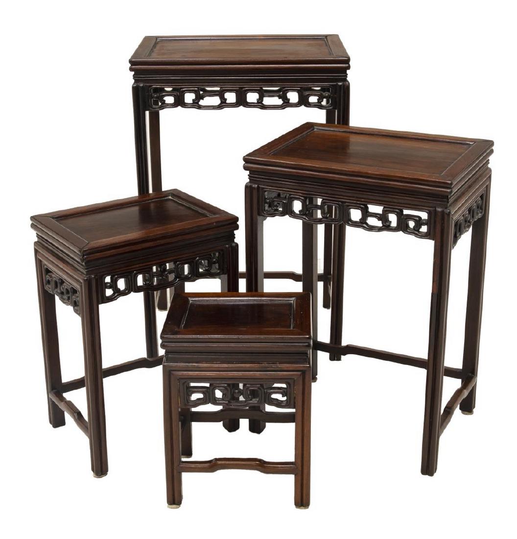 CHINESE ROSEWOOD FRETWORK NEST OF FOUR TABLES: Chinese rosewood nest of four tables, 20thc., of graduated size, each having inset panel top, over fret carved apron, on stretcher joined legs, largest: 27.75"h, 18.5"w, 13"d Start Price: $100.00