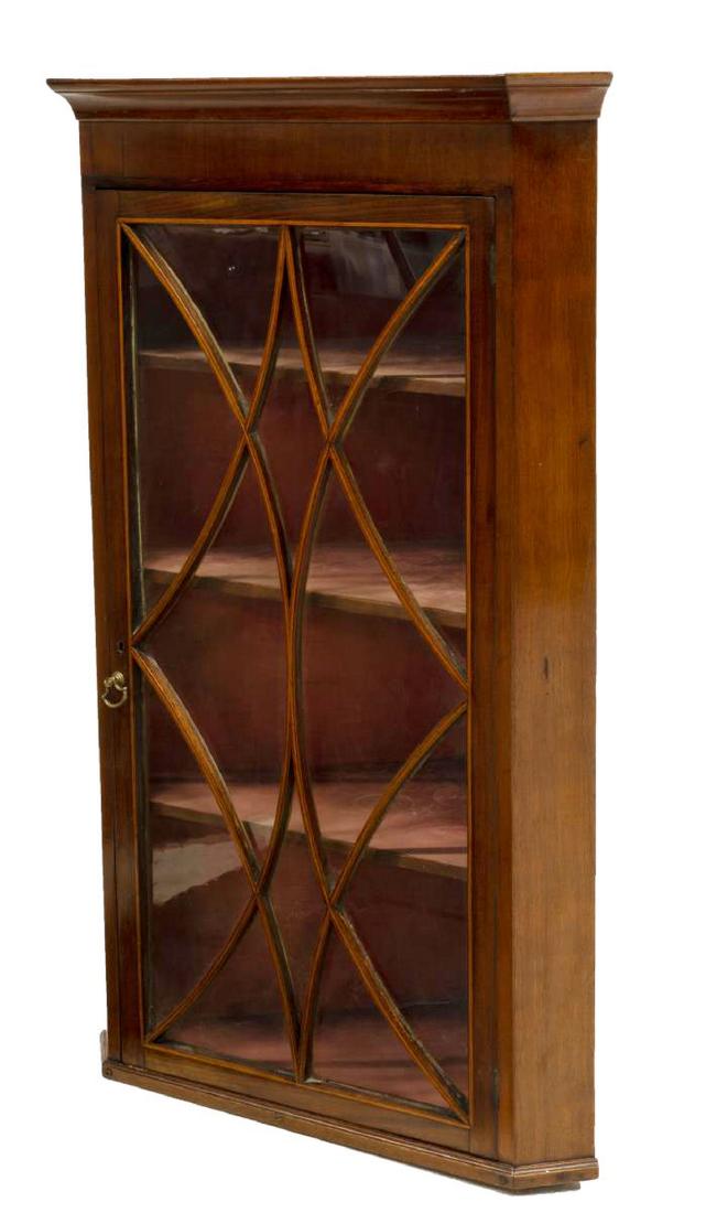 ENGLISH GEORGIAN STYLE HANGING CORNER CUPBOARD: English Georgian style mahogany hanging corner cupboard, 19th c., cornice top, canted corners, glazed door, molding with contrasting string inlay, opening to interior shelves, later hanging hardware, 
