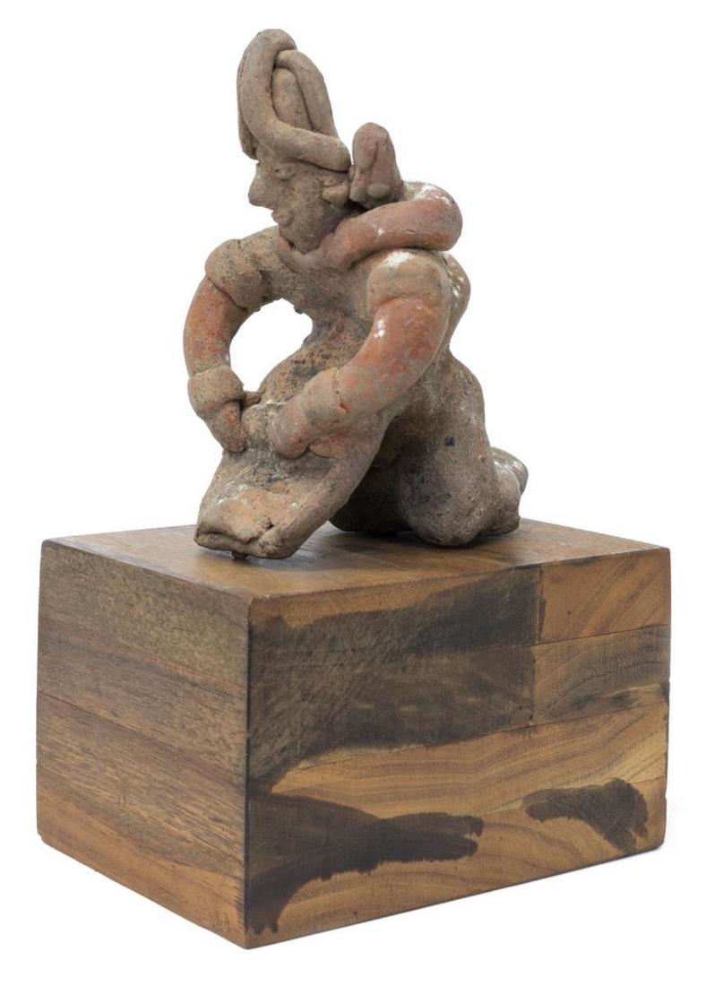 PRE-COLUMBIAN MESOAMERICA RED CLAY COLIMA FIGURE: Pre-Columbian Colima figure, Mesoamerica, 500 BC - 800 AD, red-brown clay, depicting a woman grinding corn with child on her back, accompanied by later wood stand, figure: approx 5"h, 3.25"w, 4.25"d, 