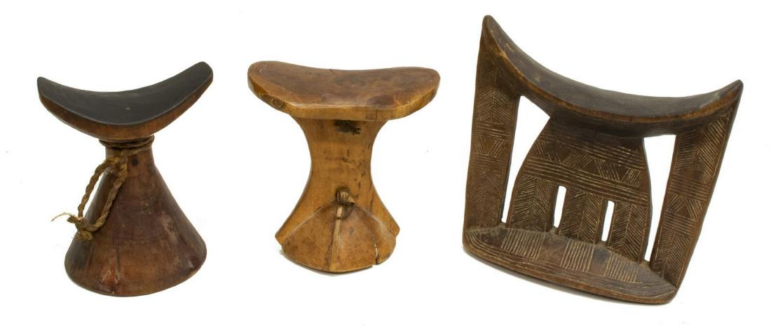(3) AFRICAN CARVED WOOD HEADRESTS, SOMALIA: (lot of 3) African carved wood headrests, the largest from Somalia with incised carving, approx 7.5/8"h, 7.3/8"w, 2.5"d, (1) Kenyan, with leather handle and (1) with rope accent, 2.25lbs Start Price: 
