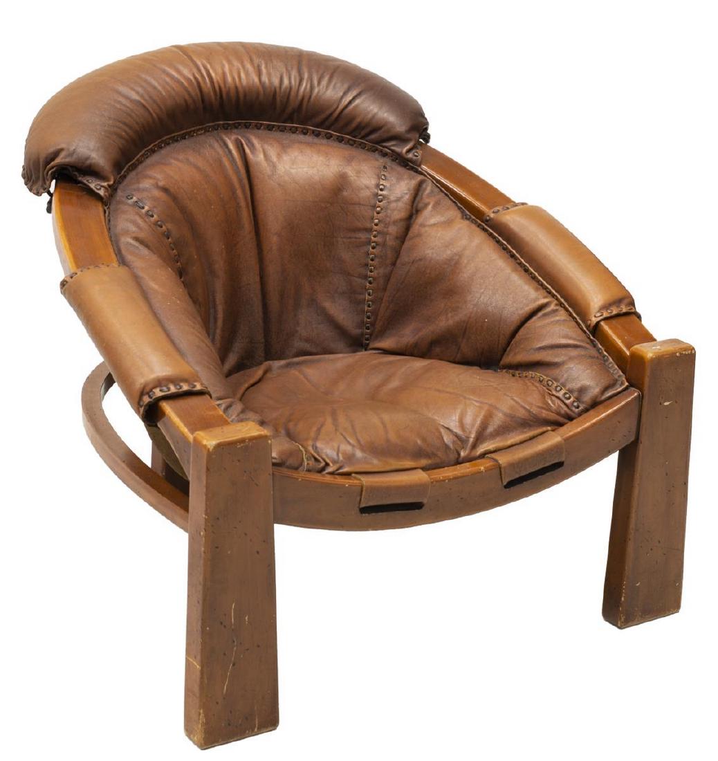 MODERN PERCIVAL LAFER STYLE LEATHER LOUNGE CHAIR: Modernist leather lounge chair, c. 1960s-1970s, in the manner of Percival Lafer (Brazil, b.1936), horseshoe shaped frame, brown leather seat, with padded head and arm rests, approx 31"h, 33.75"w, 33"d