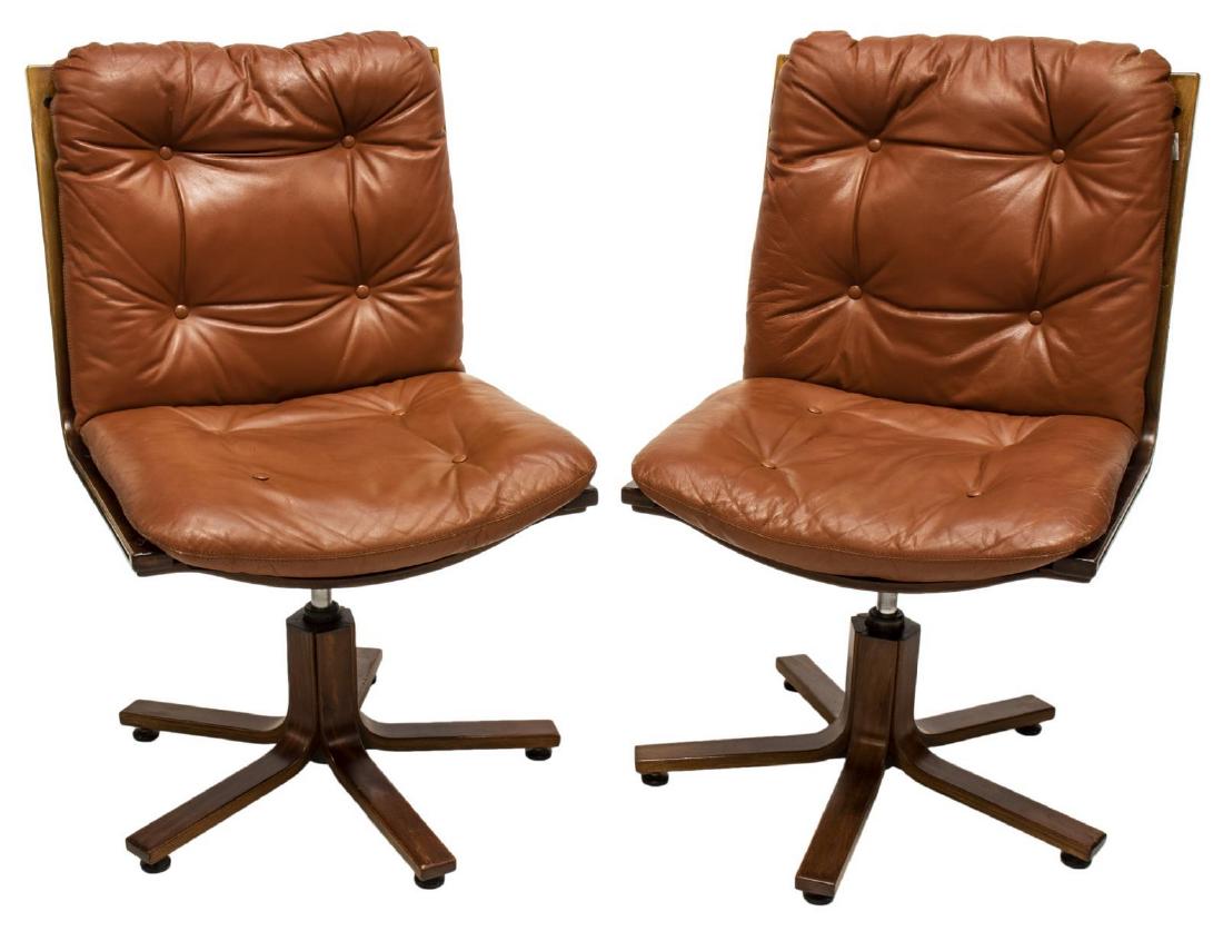(2) MID-CENTURY LEATHER SLING SEAT BENTWOOD CHAIRS: (pair) Scandinavian mid-century modern chairs, c. 1960s-1970s, having buttoned leather cushions on sling seat, swiveling on a bentwood frame, approx 37.75"h, 24"w, 21"d Start Price: $200.00