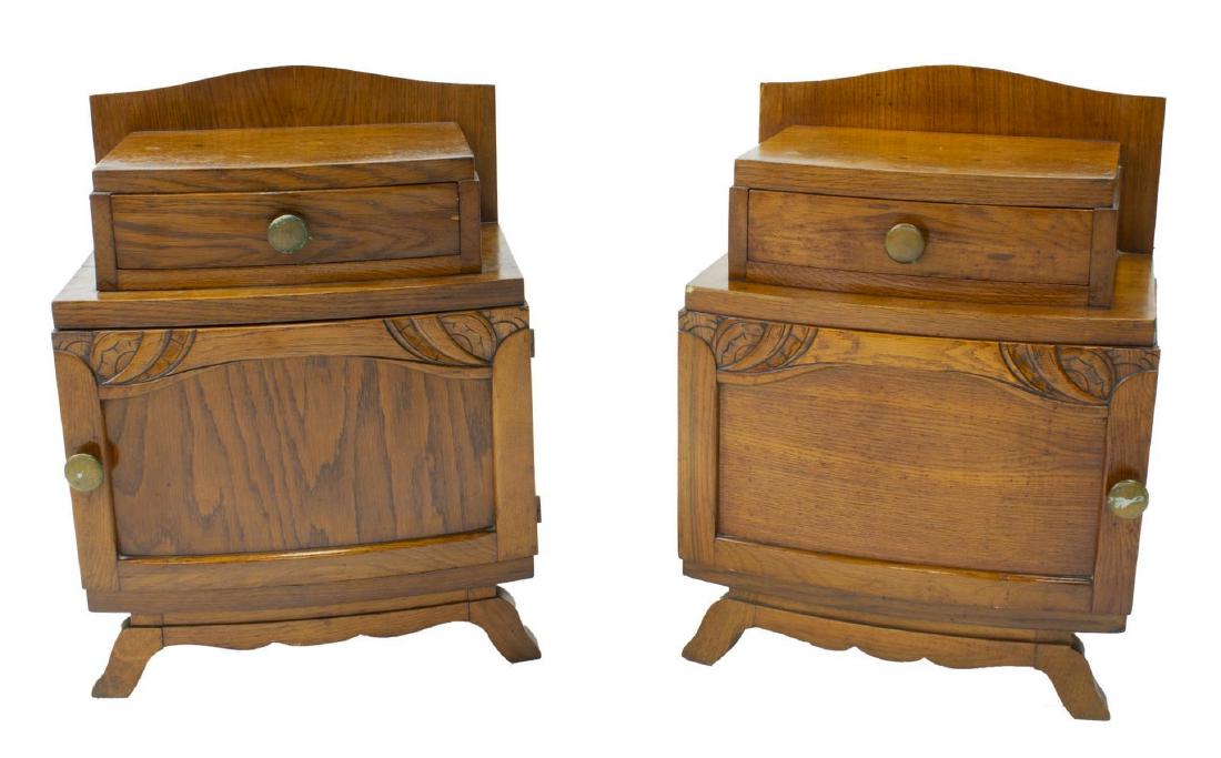 (PAIR) FRENCH ART DECO OAK BEDSIDE CABINETS: (pair) French Art Deco oak nightstands, c. 1930s-1940s, having bowed front, stepback drawer over cabinet, cabinet door with stylized carving, rising on short outswept feet, approx 24.75"h, 19"w, 13.25