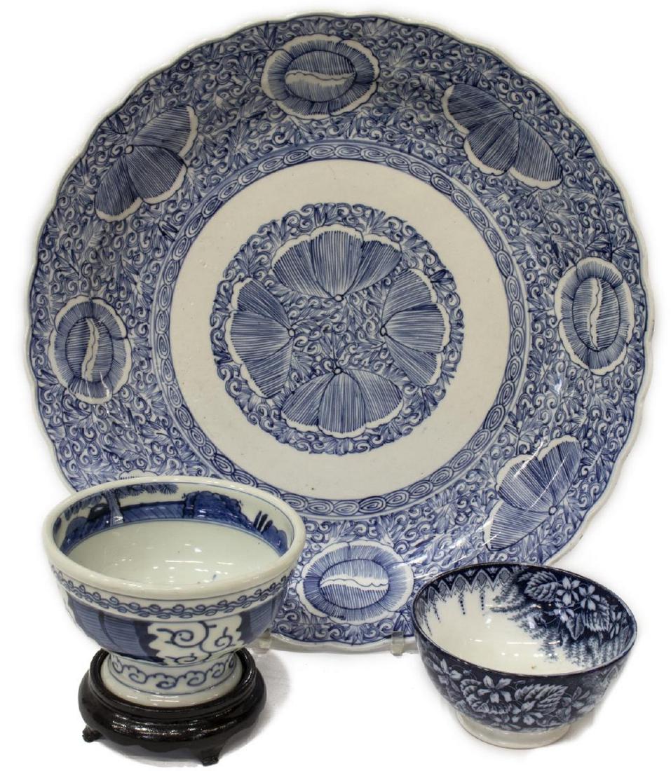 (3) CHINESE BLUE & WHITE PORCELAIN TABLEWARE: (lot of 3) Blue and white ceramic tableware, including: (1) Chinese porcelain plate, having a scalloped rim centering a floral pattern, (1) Chinese porcelain footed bowl, the sides having stylized scr