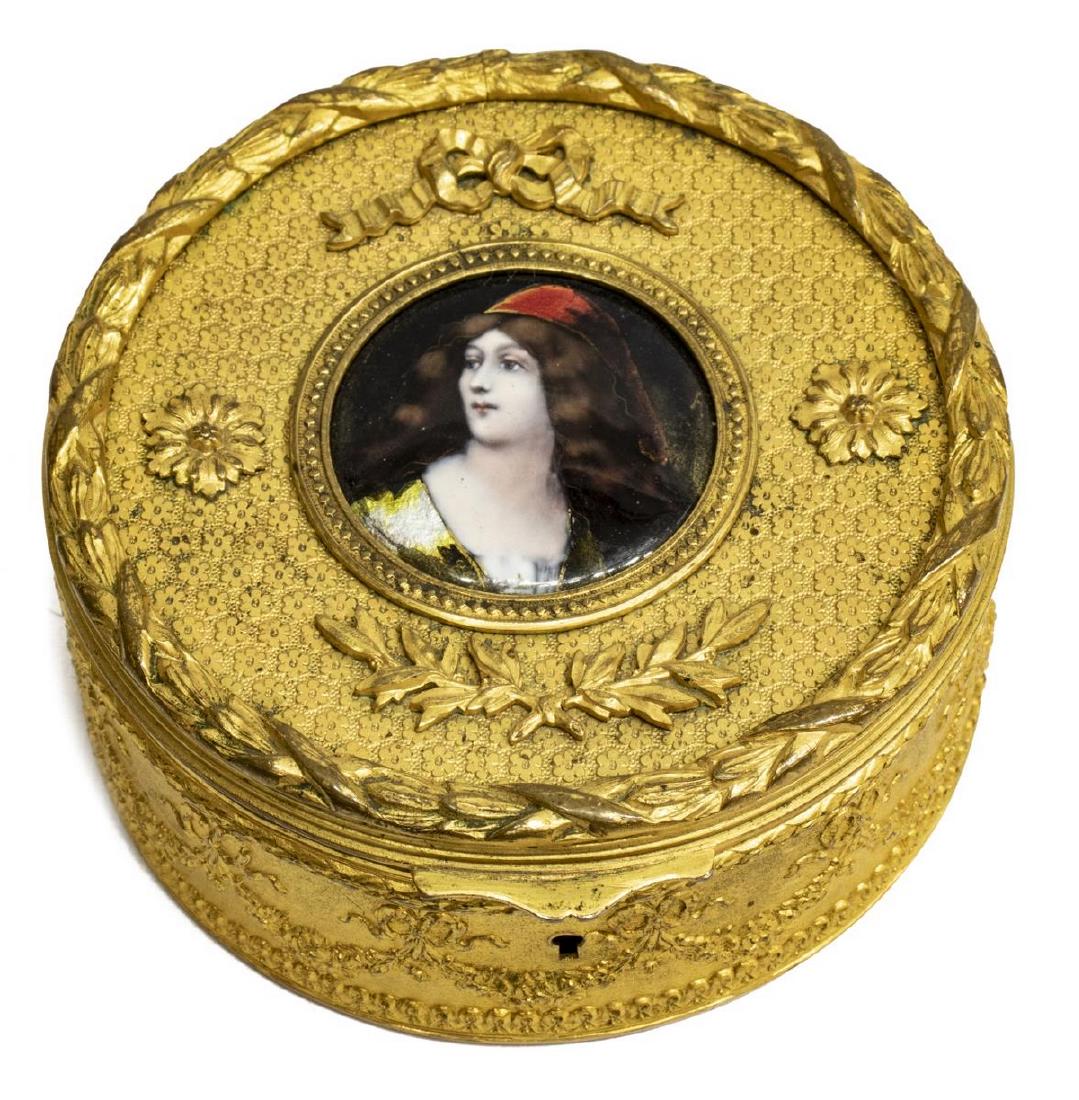 FRENCH ENAMELED PORTRAIT MINITURE GILT METAL BOX: French gilt metal table box, late 19th/ early 20th c., circular form, hinged lid set with enameled metal plaque of a beauty with foiled accents, initialed A... (?), after Angelo Asti (Italy, 1847-1903