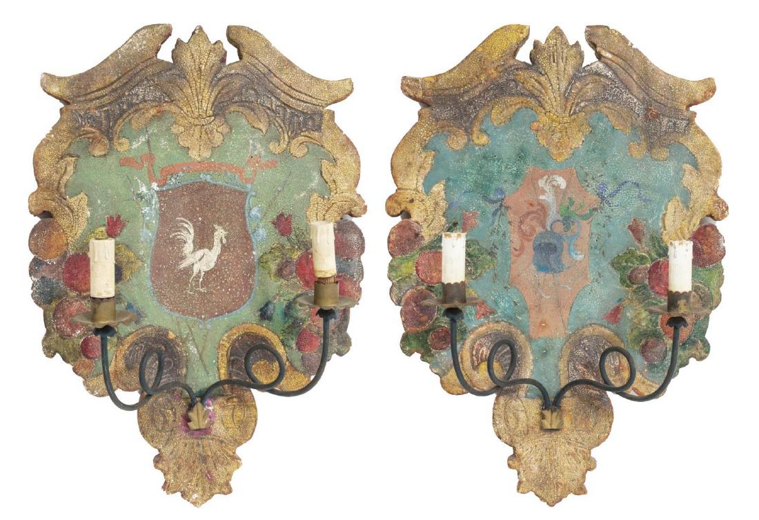 (PR) ITALIAN PAINTED WOOD & IRON TWO-LIGHT SCONCES: (pair) Italian painted wood and iron two-light wall sconces, 20th c., having shaped wood bodies, accented by fruit motifs and varied heraldic crests to center, the two curved arms each with a single l