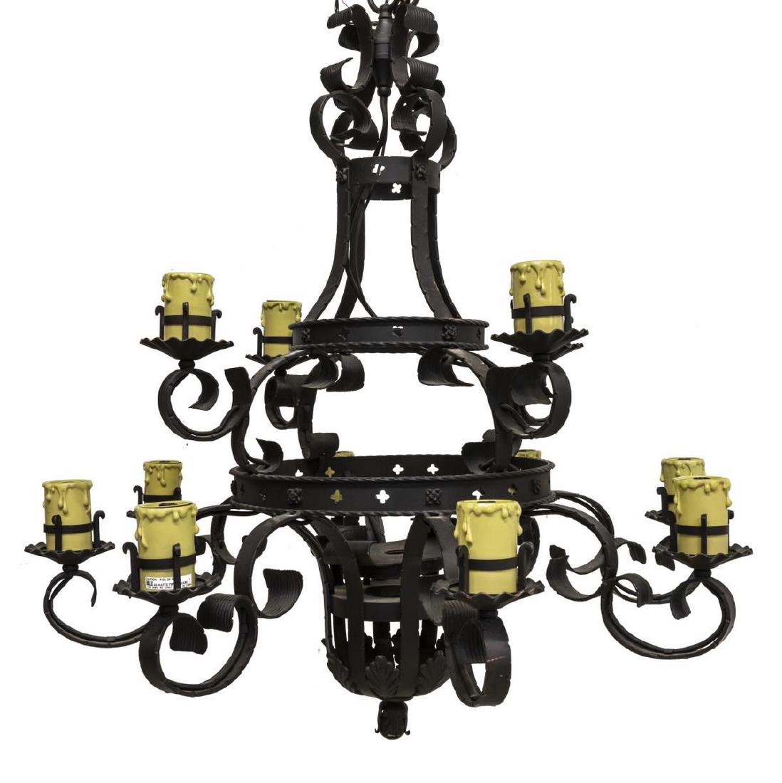 GOTHIC STYLE FORGED IRON TWELVE-LIGHT CHANDELIER: Gothic style forged iron twelve-light chandelier, 20th c., having two tiers, with single light encased in candle cover to each of twelve arms, accented by scrollwork elements, approx 37.5"h, 37.5"diam