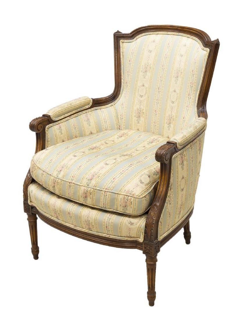LOUIS XVI STYLE BERGERE MEYER GUNTHER MARTINI MGM: Louis XVI style bergere armchair, Meyer Gunther Martini (MGM, New York, 20th c.), with arched chapeau crestrail, over upholstered back and sides, enclosed arms with padded armrests, ending in scrolled