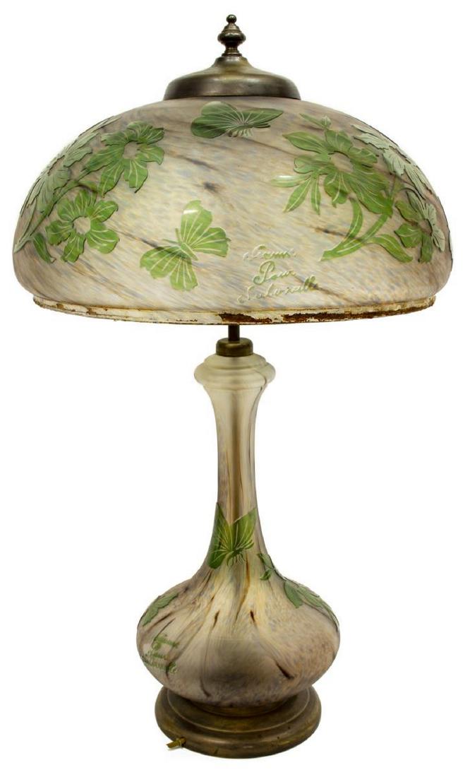 VIANNE POUR SUBERVILLE CAMEO ART GLASS TABLE LAMP: French cameo art glass table lamp, 20th c., Vianne Pour Suberville, with green floral and butterfly motif, domed shade concealing two lights, over corresponding base with flared standard, on circular 