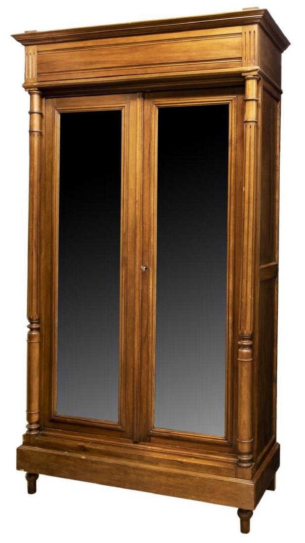 FRENCH NAPOLEON III STYLE MIRRORED WALNUT ARMOIRE: French Napoleon III style walnut armoire, early 20th c., a stepped cornice over two mirrored doors flanked by turned fluted columns, the interior with adjustable height shelves and drawers, rising on 