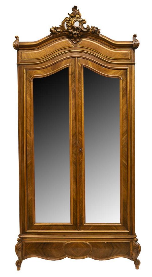 FRENCH LOUIS XV STYLE CARVED WALNUT ARMOIRE 19TH C: French Louis XV style walnut armoire, mid 19th c., carved foliates to cornice, two paneled doors with inset shaped beveled mirrors, opening to interior shelving, all over a single drawer, rising on sh