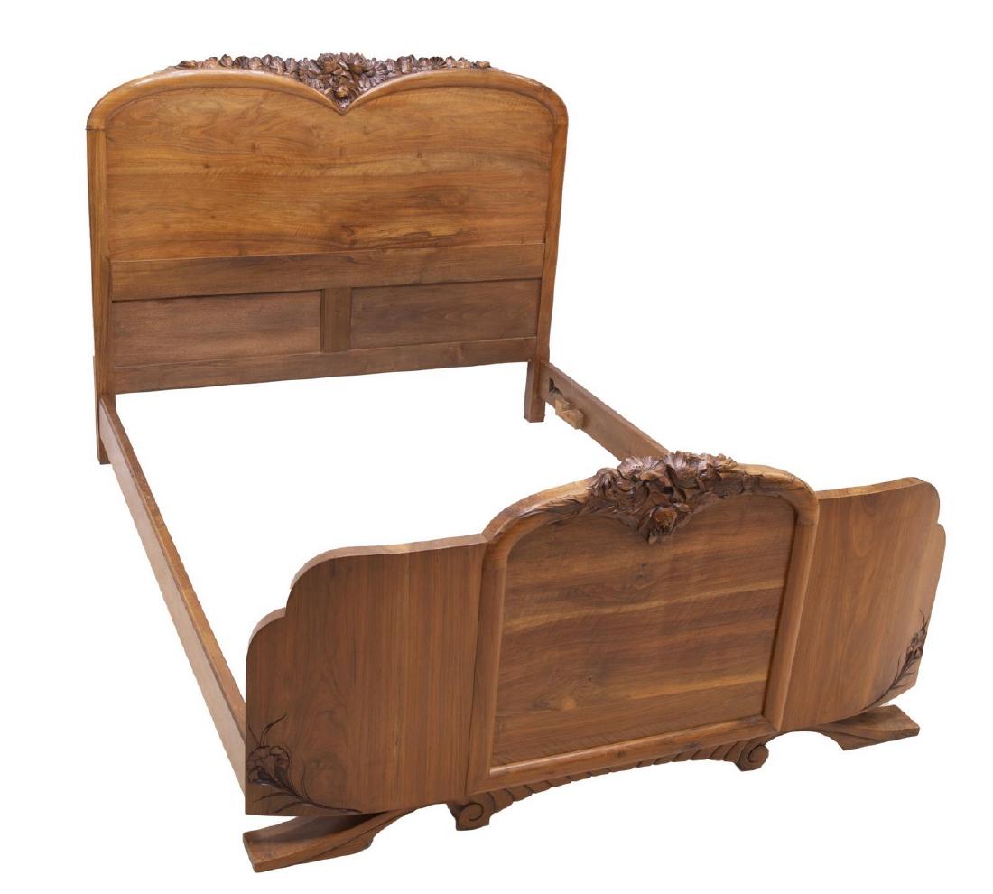 FRENCH ART NOUVEAU FLORAL CARVED WALNUT BED: French Art Nouveau walnut bed, late 19th/ early 20th c., intricately carved with floral motifs to headboard and footboard, exterior: approx 48.25"h, 59"w, 79"d, interior: approx 56.5"w, 76.75"d Start