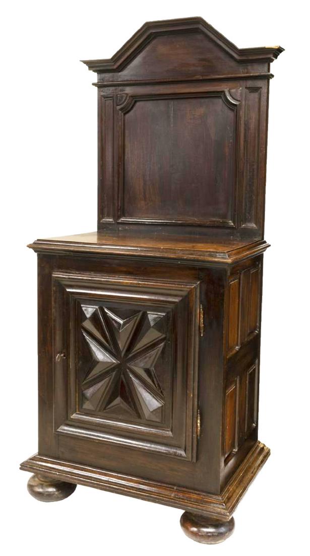FRENCH LOUIS XIII STYLE WALNUT CONFITURIER CABINET: French Louis XIII style walnut confiturier cabinet, 19thc., having a shaped and paneled splash, over a single door with raised geometric carved panel, interior shelf, rising on substantial bun feet, a