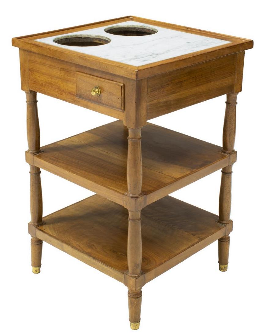 FRENCH DIRECTOIRE STYLE WALNUT WINE COOLER TABLE: French Directoire style walnut "rafraichissoir" (wine cooler table), 19th c., having inset marble top, with circular cutouts for bottle coolers, small frieze drawer, over two tiers, on turned supports