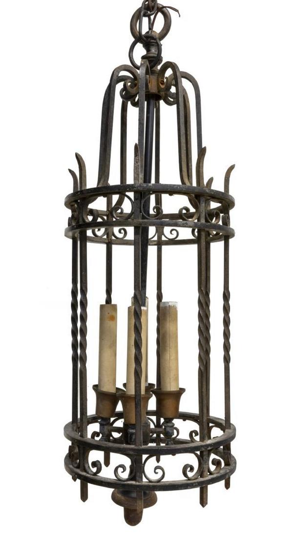 RENAISSANCE STYLE FOUR-LIGHT CEILING LAMP: Renaissance style wrought iron and brass four-light ceiling lamp, 20th c., having four lights within candle covers, encased by cage, accented by scrollwork elements and drop finial, approx 33"h, 13"di