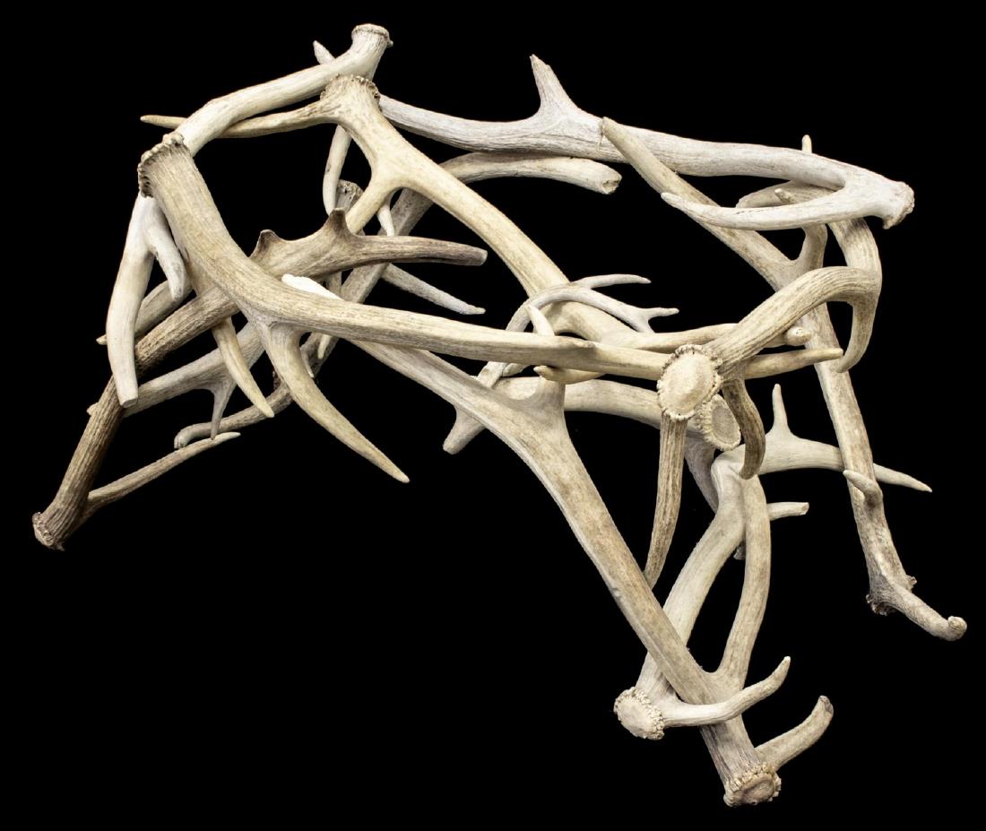 COFFEE TABLE BASE FASHIONED FROM DEER ANTLERS: Coffee table base fashioned from deer antlers, in need of glass top, approx 16.75"h, 29.75"l, 23.25"w **Provenance: From the Estate of Huey Keeney of Tyler, Texas** Start Price: $50.00