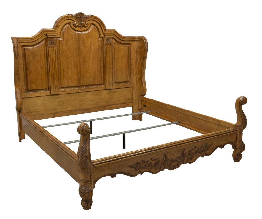 FERGUSON COPELAND LOIRE VALLEY CALIFORNIA KING BED: Ferguson Copeland 'Loire Valley' country pine California king size bed, 20th c., having running ornamentation, foliate, scrollwork and fluted accents, footboard with two posts curling into spirals at
