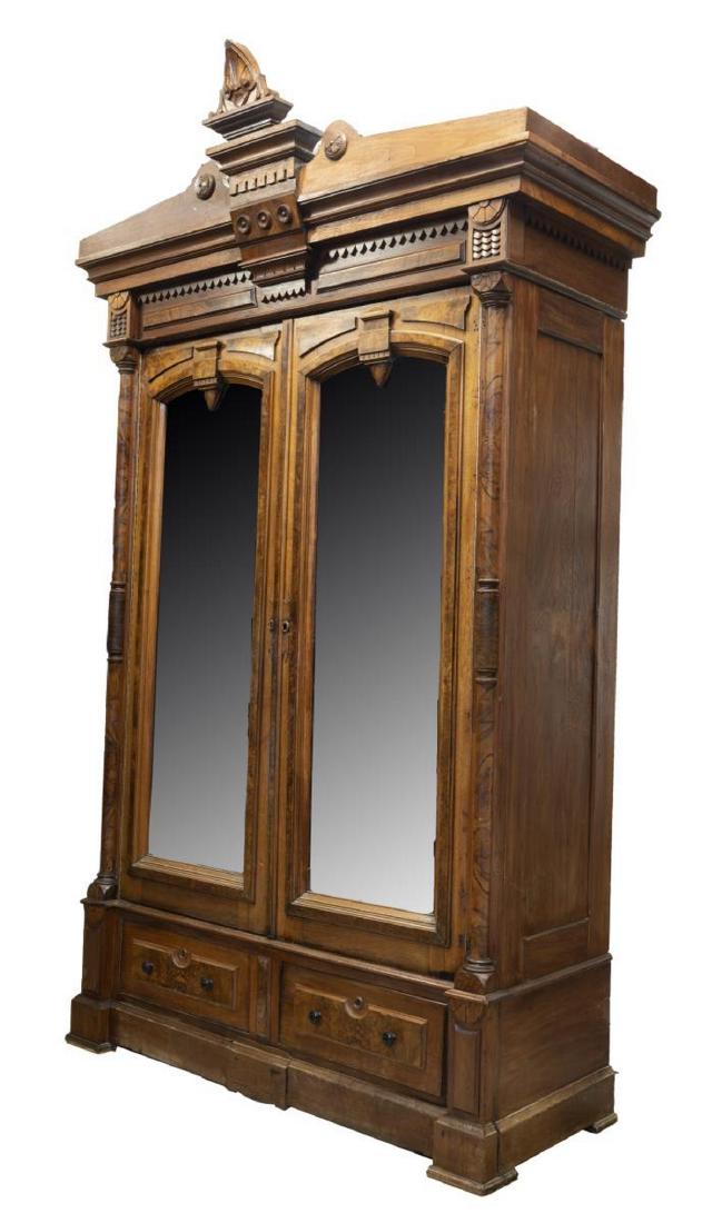 AMERICAN VICTORIAN EASTLAKE BURL WALNUT ARMOIRE: American Victorian Eastlake walnut armoire, late 19th c., having cornice top with decorative molding, accented with burlwood panels, double mirrored doors, flanked by burl-faced pilasters, over two lo