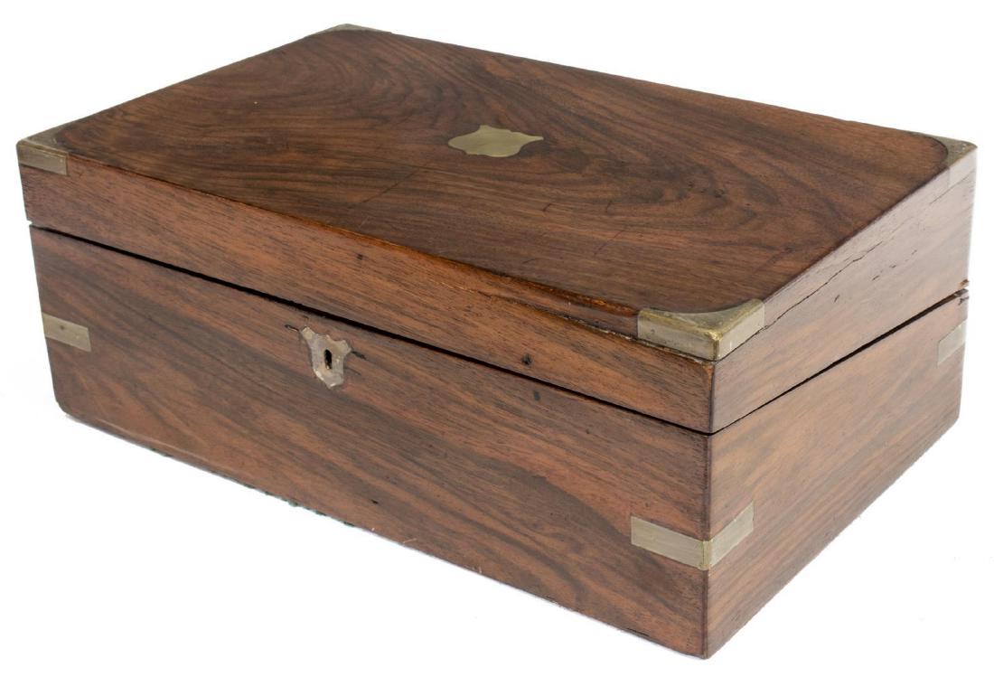 ENGLISH BRASS-BOUND TRAVELING WRITING LAP DESK: English brass-bound lap desk, 19th c., having inset sheild form cartouche and escutcheon, interior with worn writing surface, storage, ink receptacles and pen slot, interior slant surfaces not locking