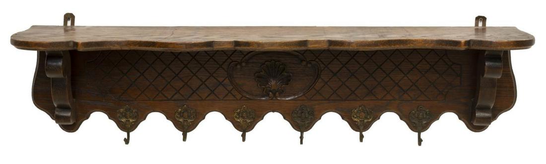 FRENCH OAK WALL-HANGING COAT & HAT RACK SHELF: French oak hat rack, 20th c., having six gilt metal hooks, on a shell carved back, approx 10.75"h, 44"w, 8.25"d Start Price: $100.00