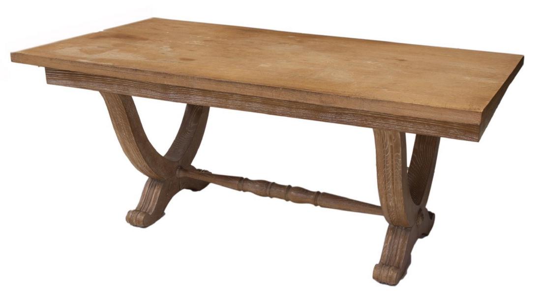 CONTINENTAL CERUSED OAK DINING TABLE: Continental cerused oak dining table, 20th c., the rectangular top over a shaped trestle base, rising on paw feet, approx 29"h, 71"w, 35.5"d Start Price: $300.00