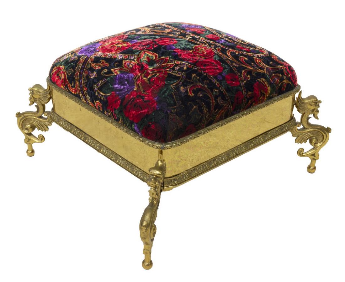 VICTORIAN GRIFFIN BRASS UPHOLSTERED FOOTSTOOL: Victorian brass foot stool/ ottoman, padded upholstered top, in later floral patterned velvet textile, brass frame, on legs as winged griffin, approx 14"h, 23.5"w, 22"d Start Price: $80.00