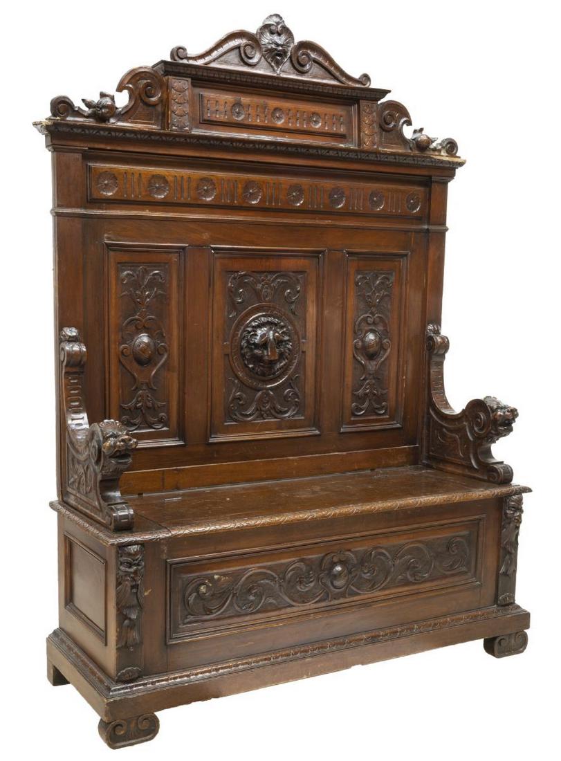 ITALIAN RENAISSANCE REVIVAL CARVED HALL BENCH: Italian Renaissance Revival hall bench, 19th c., carved with rosettes, running ornamentation, scrollwork and fruit motifs, lion's head in relief to back, grotesque handholds and accents, hinged seat r