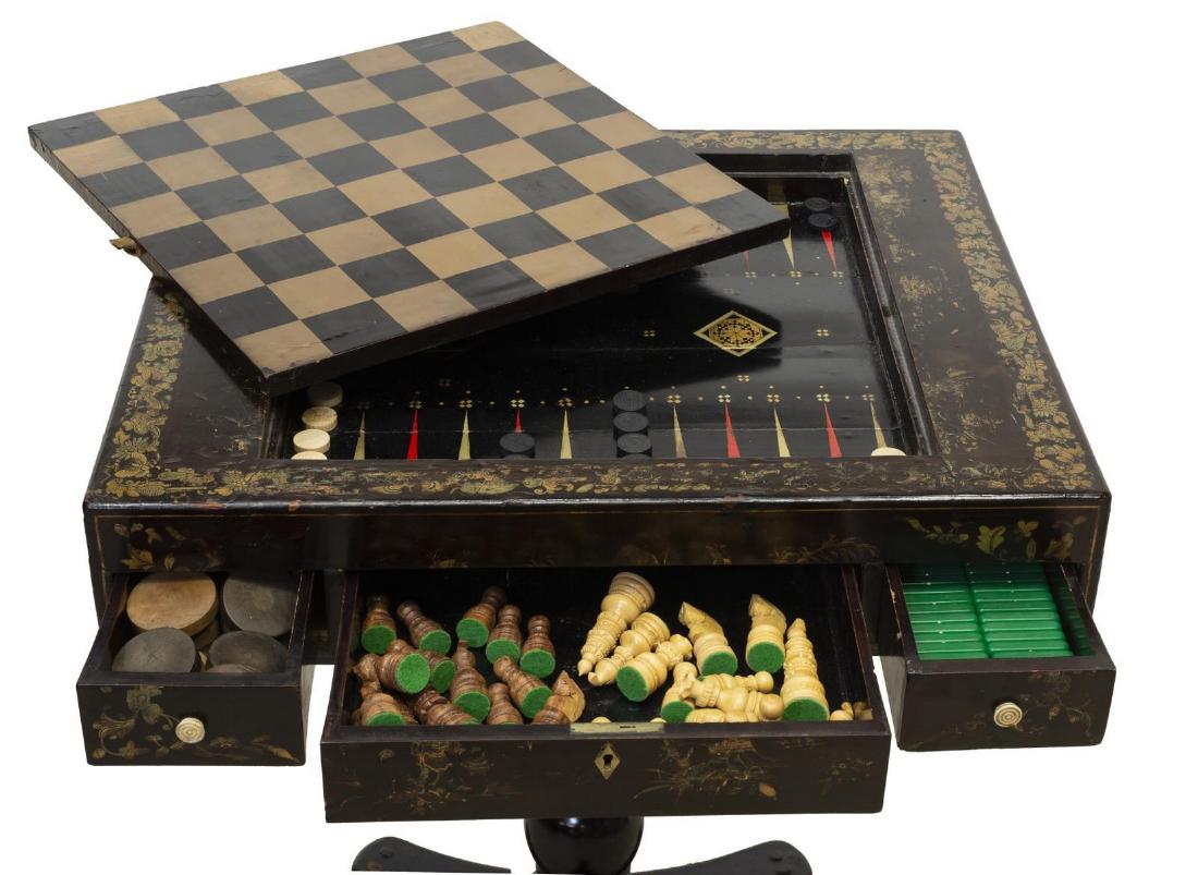 CHINESE EXPORT PARCEL GILT PAW FOOT GAMES TABLE: Chinese export parcel gilt lacquer games table, 19thc., gilded butterflies and foliate vines trim, the removable top painted to one side with figures playing board games and a chess board to the other