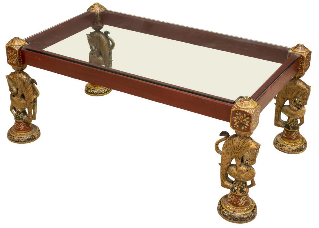 INDIA TIGER & BIRD ARCHITECTURAL COFFEE TABLE: India polychromed wood architectural elements, each carved as a tiger attacking a bird, now fashioned as the legs of a coffee table, with inset glass top, approx 17.5"h, 42 5/8"l, 24.25"w **Provenance